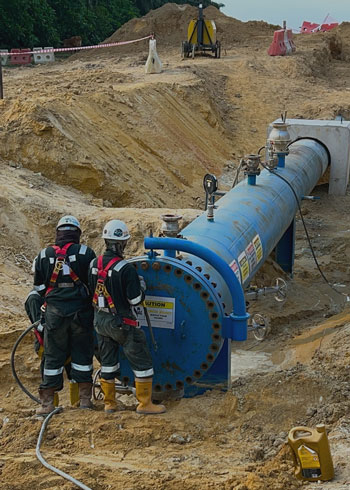 Engineers working on pipeline pre-commissioning.